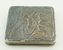 A silver compact, unmarked, decorated with abstract figures, 6.5cm x 6.