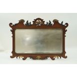 A George I style mahogany fret frame wall mirror, the pierced crest with parcel gilt eagle,