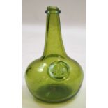 A green glass blown wine bottle with applied collar and seal,