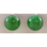 A pair of jade ear screw earrings, the hemispherical stones of approximately 11.