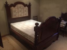A mahogany framed bed with shaped,