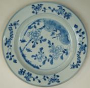 A Chinese export porcelain plate painted in underglaze blue with peony and bamboo issuing from a