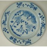 A Chinese export porcelain plate painted in underglaze blue with peony and bamboo issuing from a