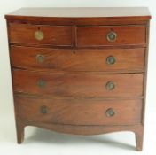 A George IV mahogany bow fronted chest of two short and three long drawers with ring handles and