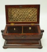 A William IV mahogany tea caddy with sarcophagus top and bombe body with two ring handles on round