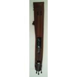 A brown leather gun slip with built in metal stand,