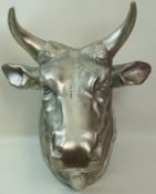 A cast model of a bulls head, with wall hanging plate to the rear, approximately 64cm high,
