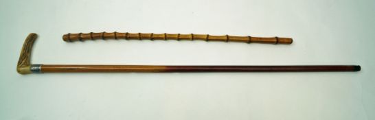 An early 20th century walking stick with horn handle and silver collar,