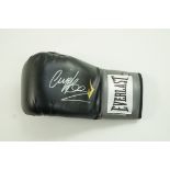 A black Everlast boxing glove, signed by Nigel Benn,