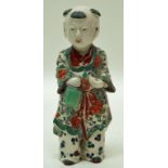 A Chinese porcelain figure, painted in coloured enamels with flowers on his robe,