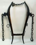 A pair of oak and cast iron horse hames, chains and leather fixings,