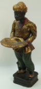 A painted plaster Venetian style figure of a moor standing holding a shell shaped dish on plinth