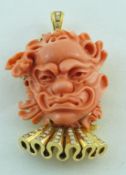 A carved coral brooch/pendant,