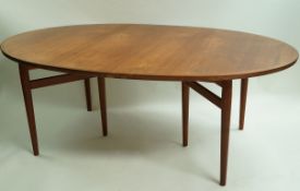 A 20th century Danish teak extending dining table with two additional leaves,