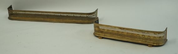 A small Victorian pierced brass fender on bun feet, 75.