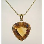 A large heart shaped citrine pendant, stamped '585' to the bale and to the chain,