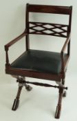 A rosewood and brass inlaid elbow chair with drop in leather seat on turned X frame legs linked by