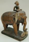 An early 20th century carved and painted Indian figure of an elephant and rider,