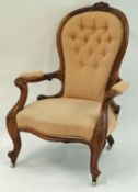 A Victorian mahogany show frame armchair with button back and cabriole legs on casters