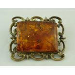 A Victorian rectangular brooch, with a panel of clarified amber to the centre, 5.