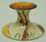 A Clarice Cliff pottery candlestick, painted in coloured enamels with a stylised landscape,