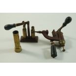 Three vintage brass cartridge reloading tools,