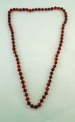 A string of cherry amber beads, the seventy four beads of approximately 1.