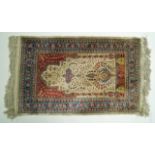 A silk prayer rug with flowers on a yellow field within five borders,