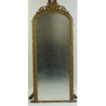 A Victorian pier glass with gilded frame surmounted by a cartouche with scrolling foliage,
