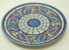 A Crown Ducal wall plate with tube lined decoration by Charlotte Rhead in the form of a wide band