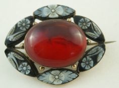 An amber and cameo brooch, the central cabochon enclosed by floral cameos, locket back,