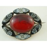 An amber and cameo brooch, the central cabochon enclosed by floral cameos, locket back,