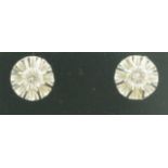 A pair of single stone diamond ear studs, the brilliant cuts totalling approximately 0.