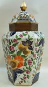 A large early 19th century porcelain floor standing hexagonal vase and cover,