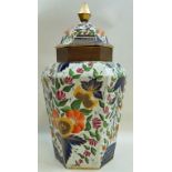 A large early 19th century porcelain floor standing hexagonal vase and cover,