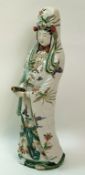 A Chinese Kangxi style porcelain figure of a Bodhiattva, standing holding a scroll,