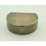 A silver pill box, London 1979, of almost lunette shape, engine turned decoration, 5cm long,