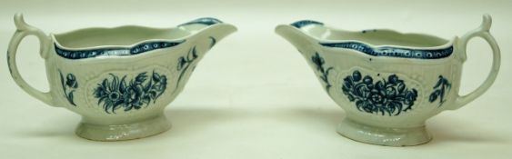 A pair of Worcester moulded sauce boats, printed on blue with flowers, open crescent mark,