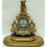 A 19th century French mantel clock with gilt metal case inset with Sèvres style plaques painted