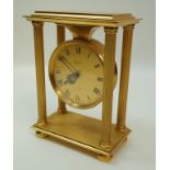 An Imhof gilded mantel clock, the circular dial flanked by four pillars,