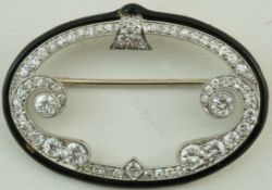 A diamond and black enamel oval Cloche brooch, signed 'Cartier N.Y.' and indistinctly numbered, 4.