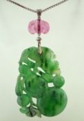 A carved jade pendant, the jade carved as a peach,