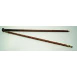 A mahogany walking cane with shell case top, 85cm long and another with flared carved handle,