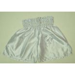 A pair of white boxing shorts signed by Larry Holmes,