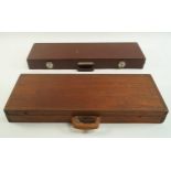 A mahogany gun case with foam interior,