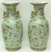 A large pair of 19th century Cantonese vases, each decorated with butterflies,