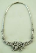 A French diamond necklace, the foliate frontispiece of flower heads set with brilliant cuts,