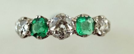 An emerald and diamond five stone ring, the three old brilliant cuts totalling approximately 0.