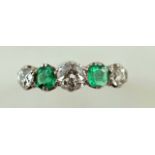 An emerald and diamond five stone ring, the three old brilliant cuts totalling approximately 0.