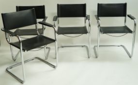 A set of four chrome cantilever chairs each with black leatherette backs and seats